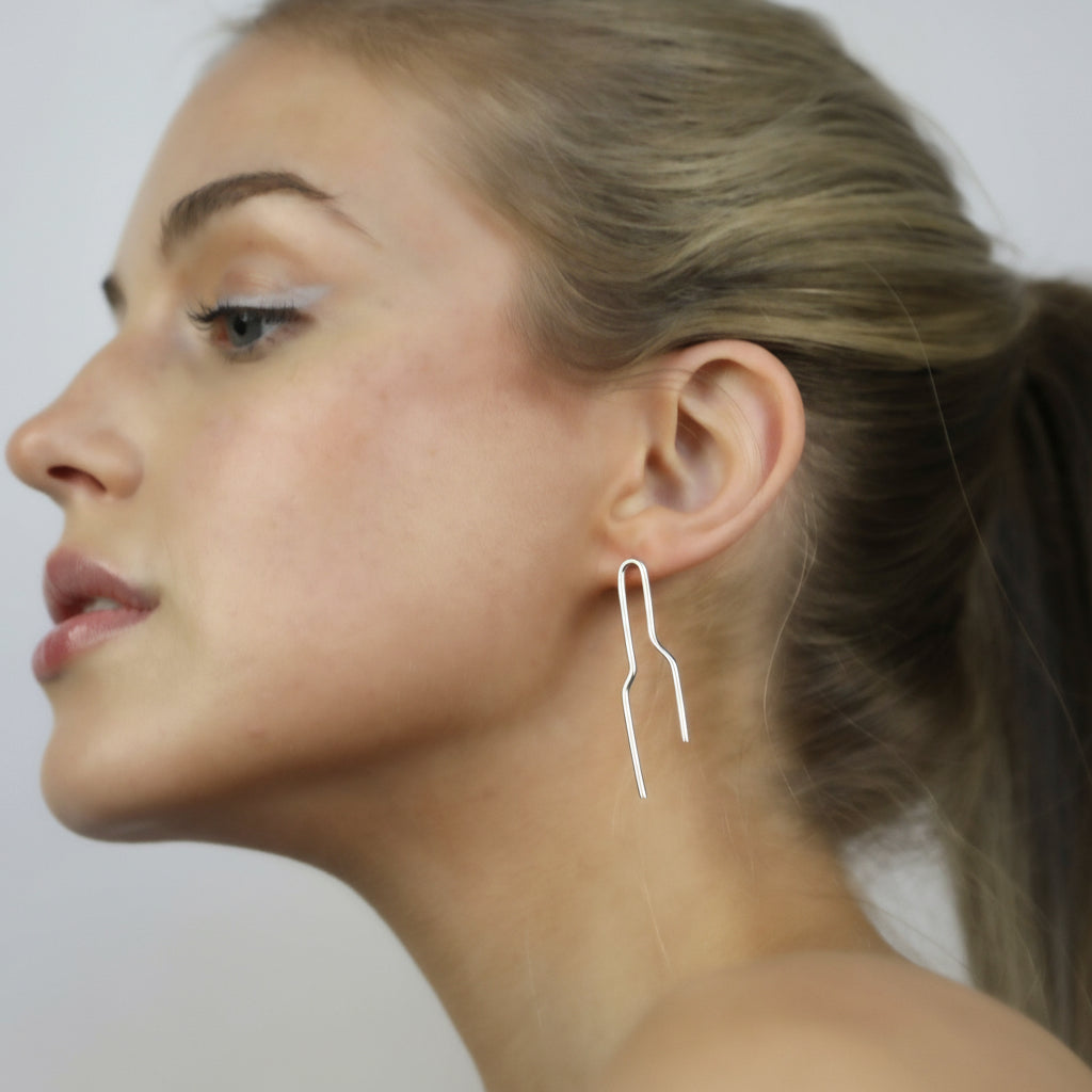 Model wearing Noelle Earrings Silver, Aura by Gabby Collection - Gabby C Thomas  - Iza by Silvia D'Avila, handmade one-of-a-kind sculptural artsy jewelry, New York