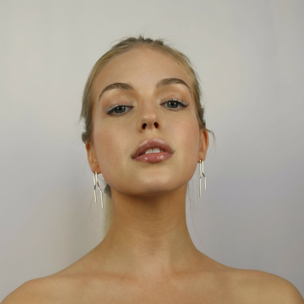 Model wearing Noelle Earrings Silver, Aura by Gabby Collection - Gabby C Thomas  - Iza by Silvia D'Avila, handmade one-of-a-kind sculptural artsy jewelry, New York
