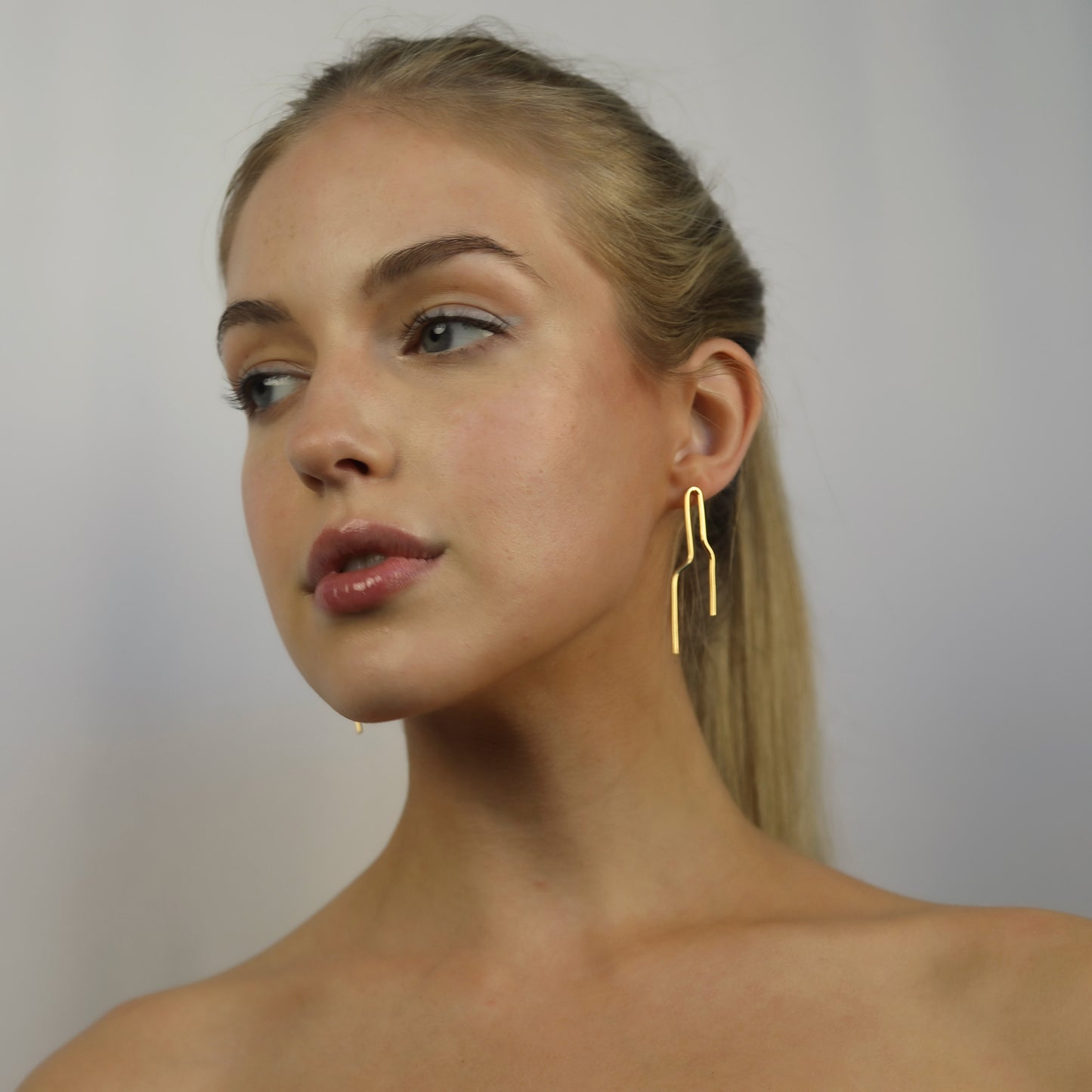 Model wearing Noelle Earrings Gold, Aura by Gabby Collection - Gabby C Thomas  - Iza by Silvia D'Avila, handmade one-of-a-kind sculptural artsy jewelry, New York
