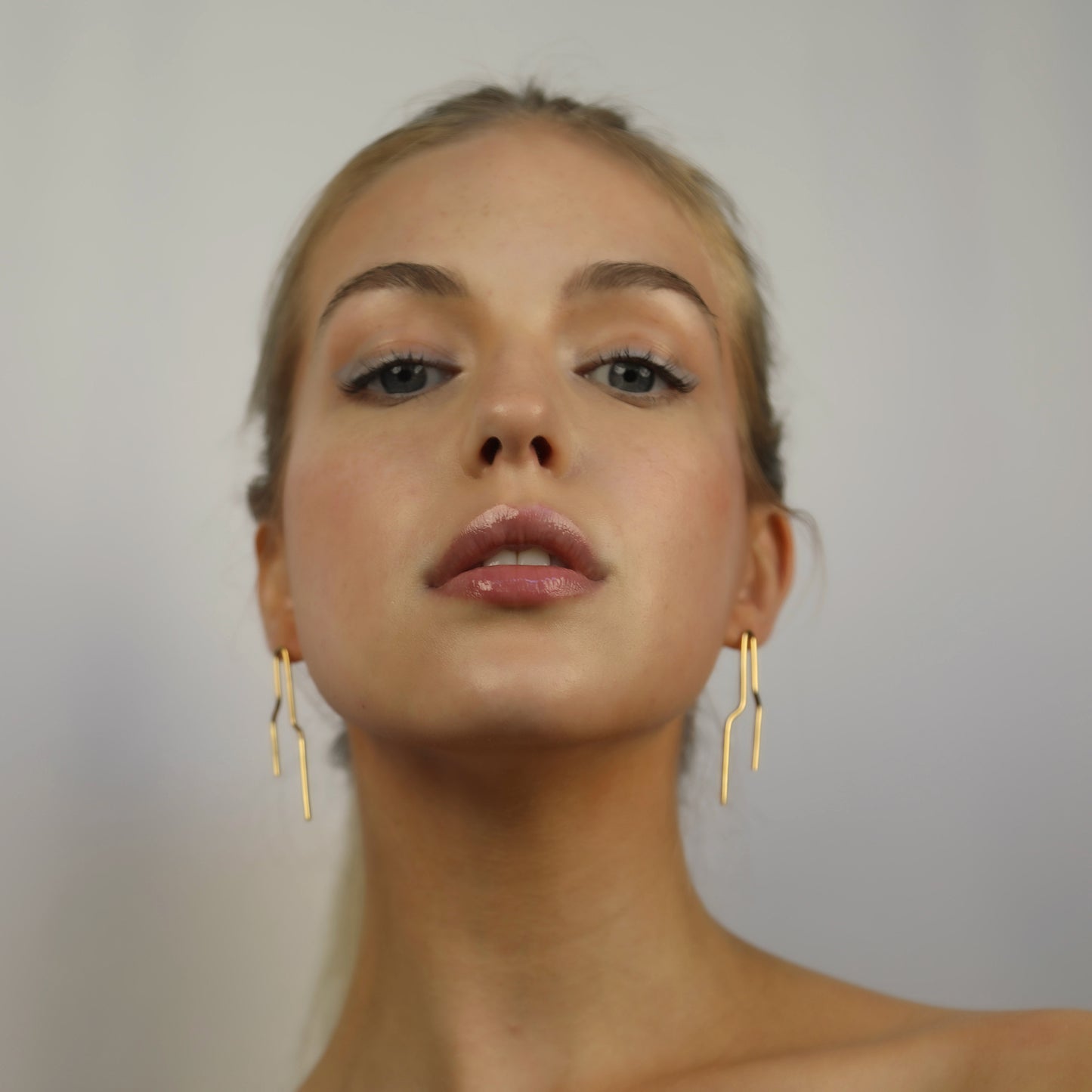 Model wearing Noelle Earrings Gold, Aura by Gabby Collection - Gabby C Thomas  - Iza by Silvia D'Avila, handmade one-of-a-kind sculptural artsy jewelry, New York