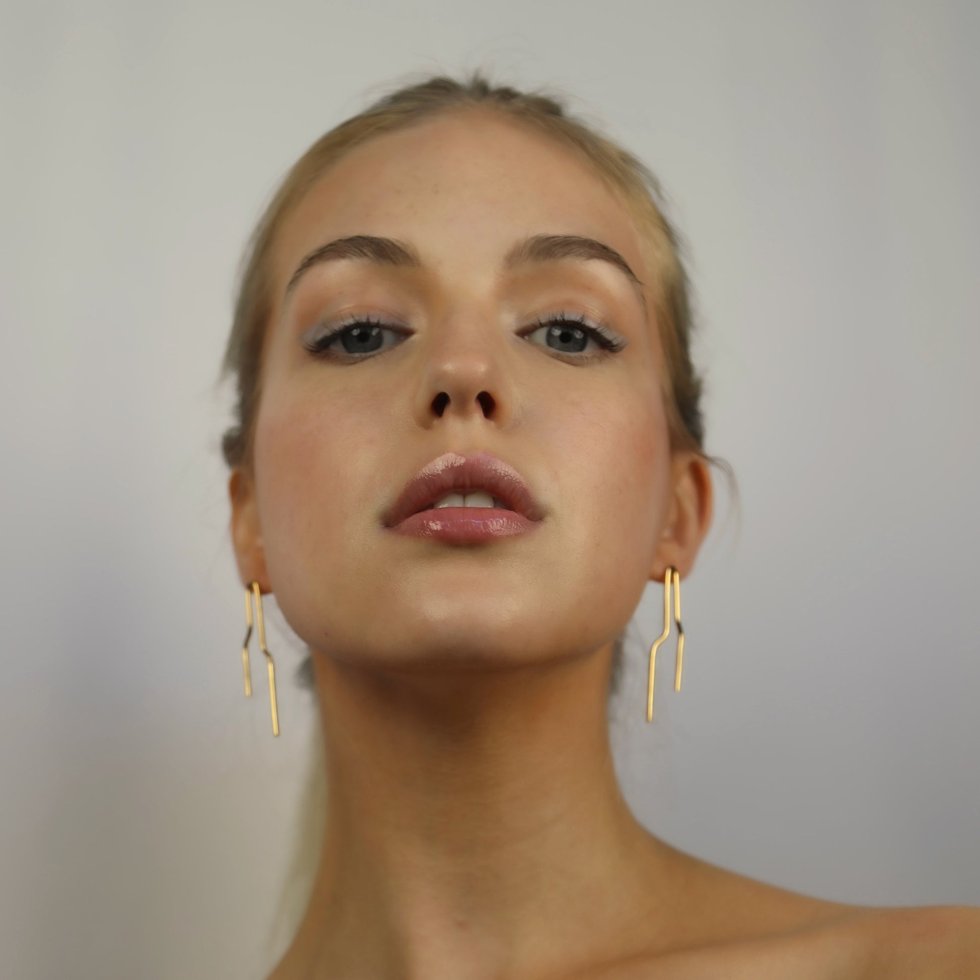 Model wearing Noelle Earrings Gold, Aura by Gabby Collection - Gabby C Thomas  - Iza by Silvia D'Avila, handmade one-of-a-kind sculptural artsy jewelry, New York